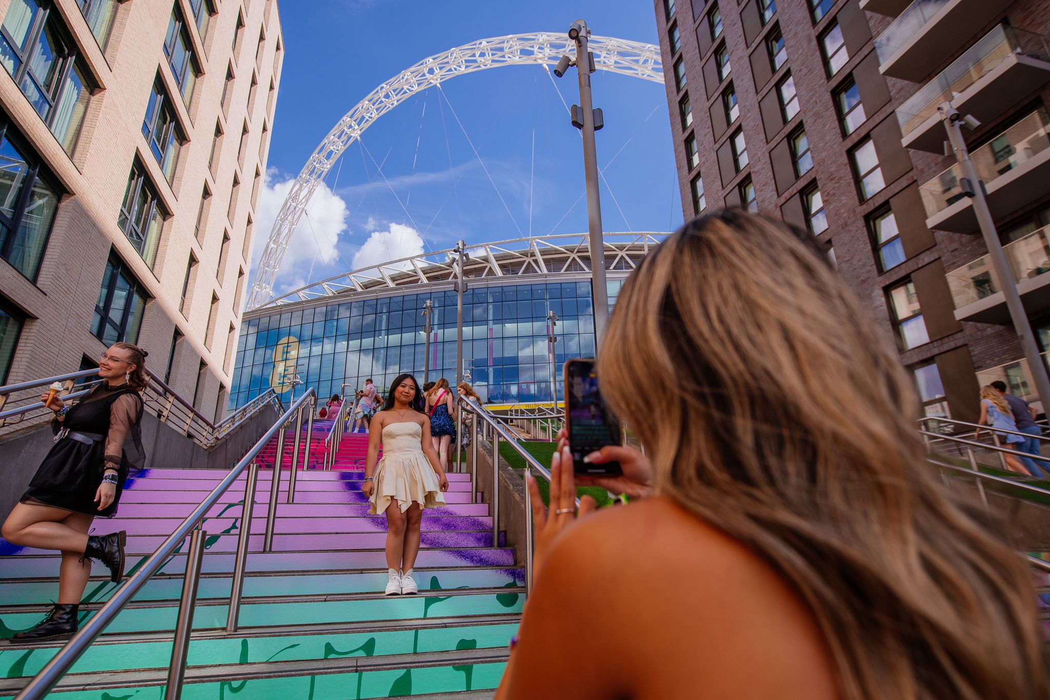 A Taylor Swift fan poses on the Swiftie Steps