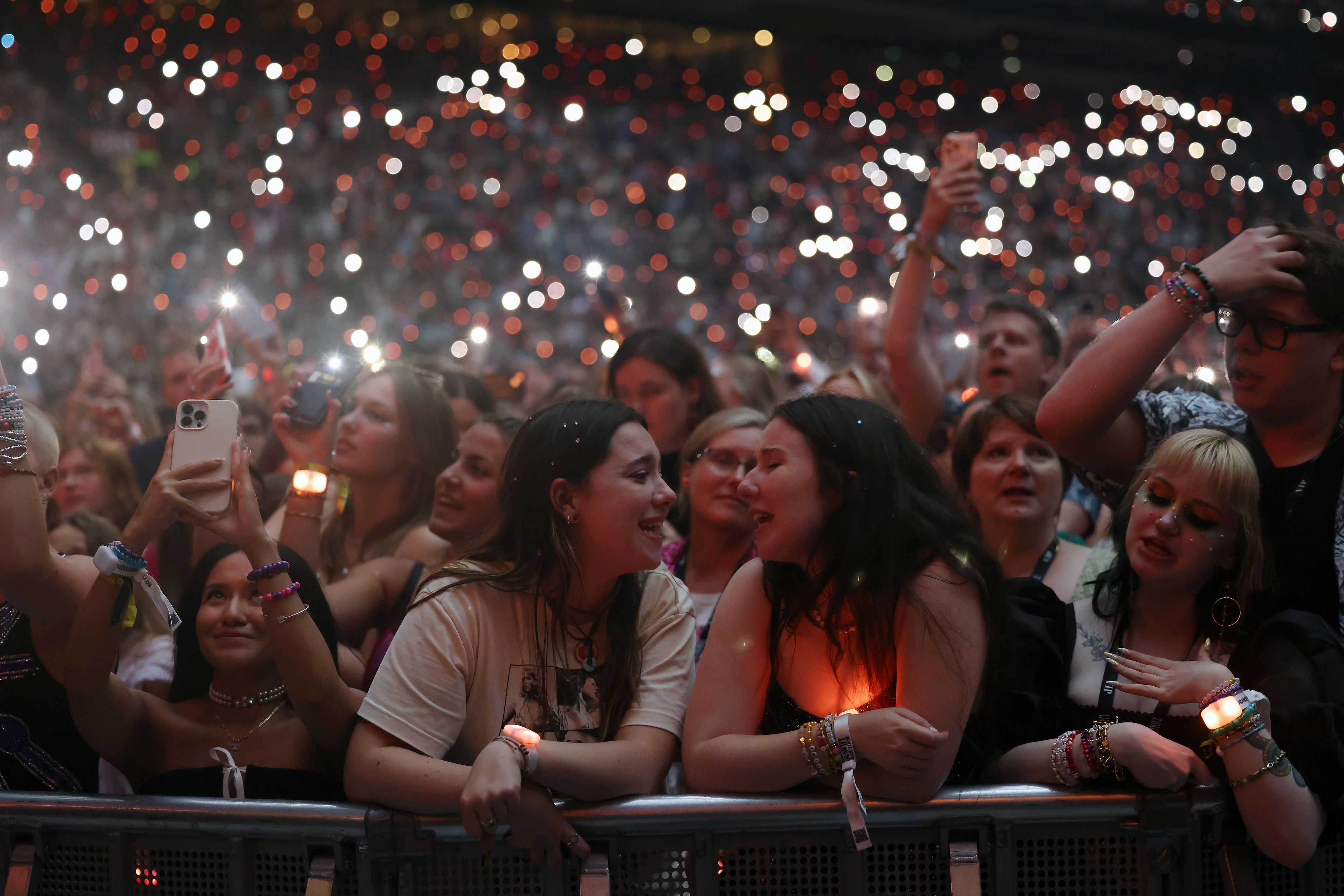 Taylor Swift fans sing a long and use their phone torches during The Eras Tour