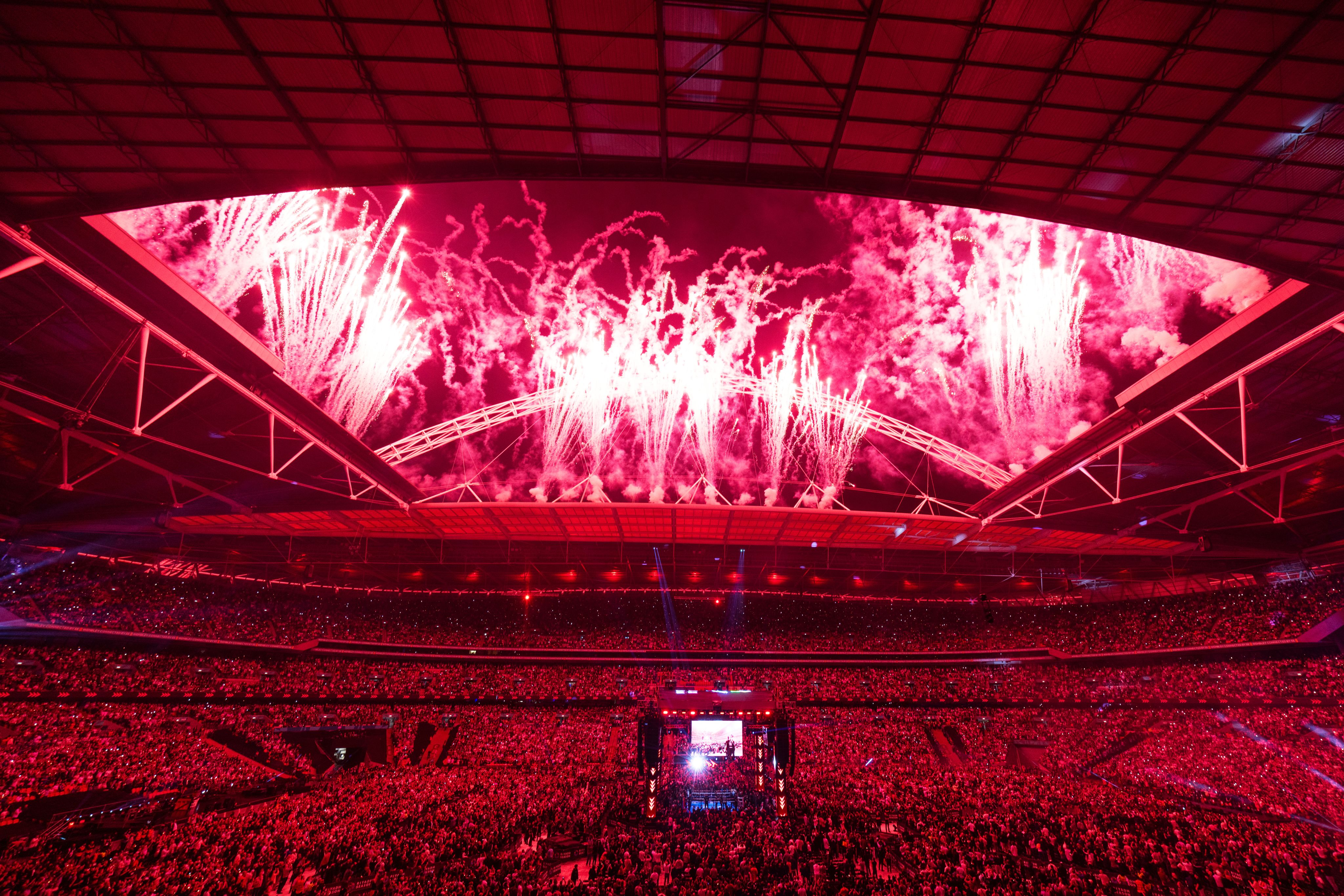 Fireworks are released from the roof and arch of the stadium
