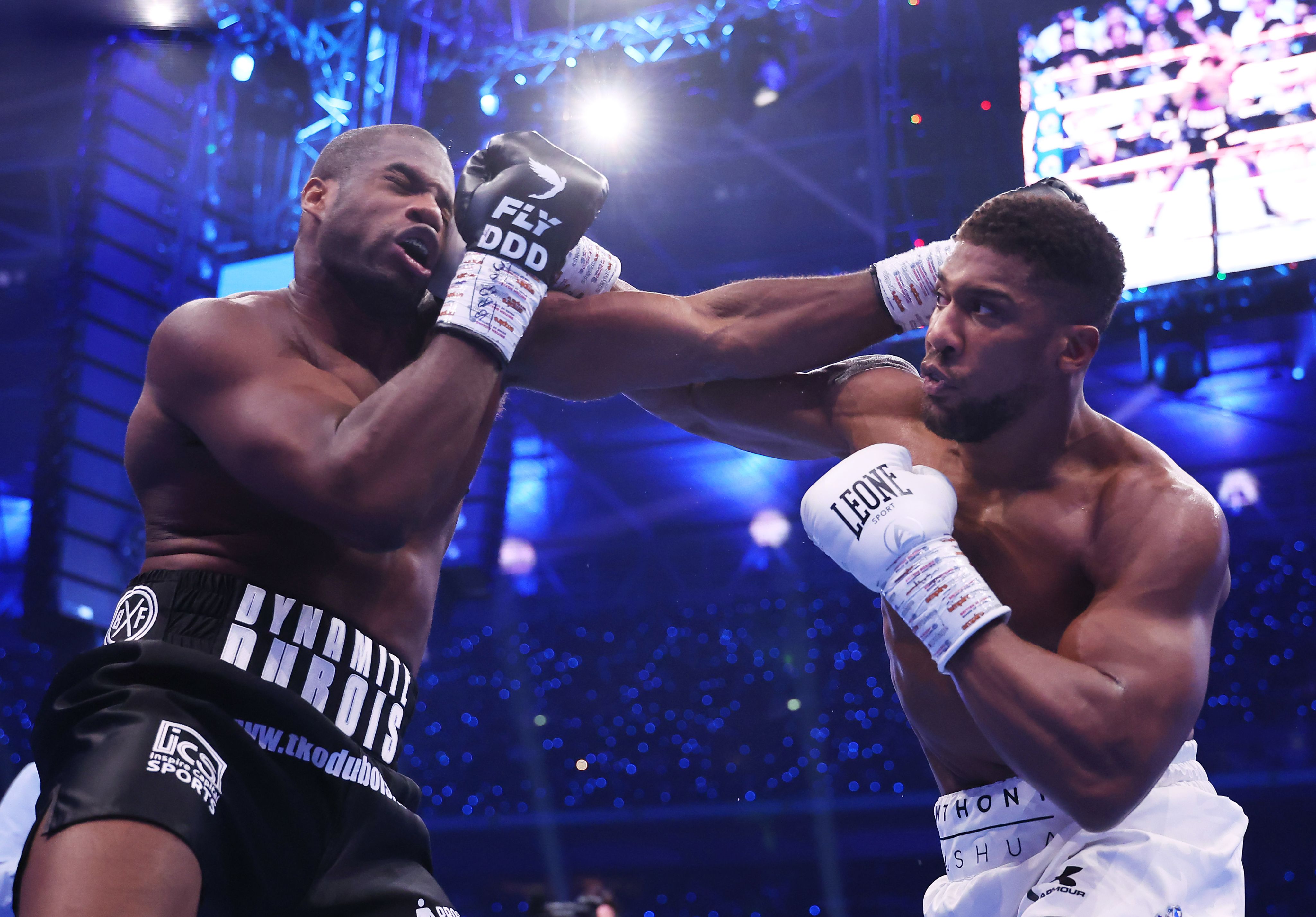 Both fighters throw punches in the early rounds of the  fight. 
