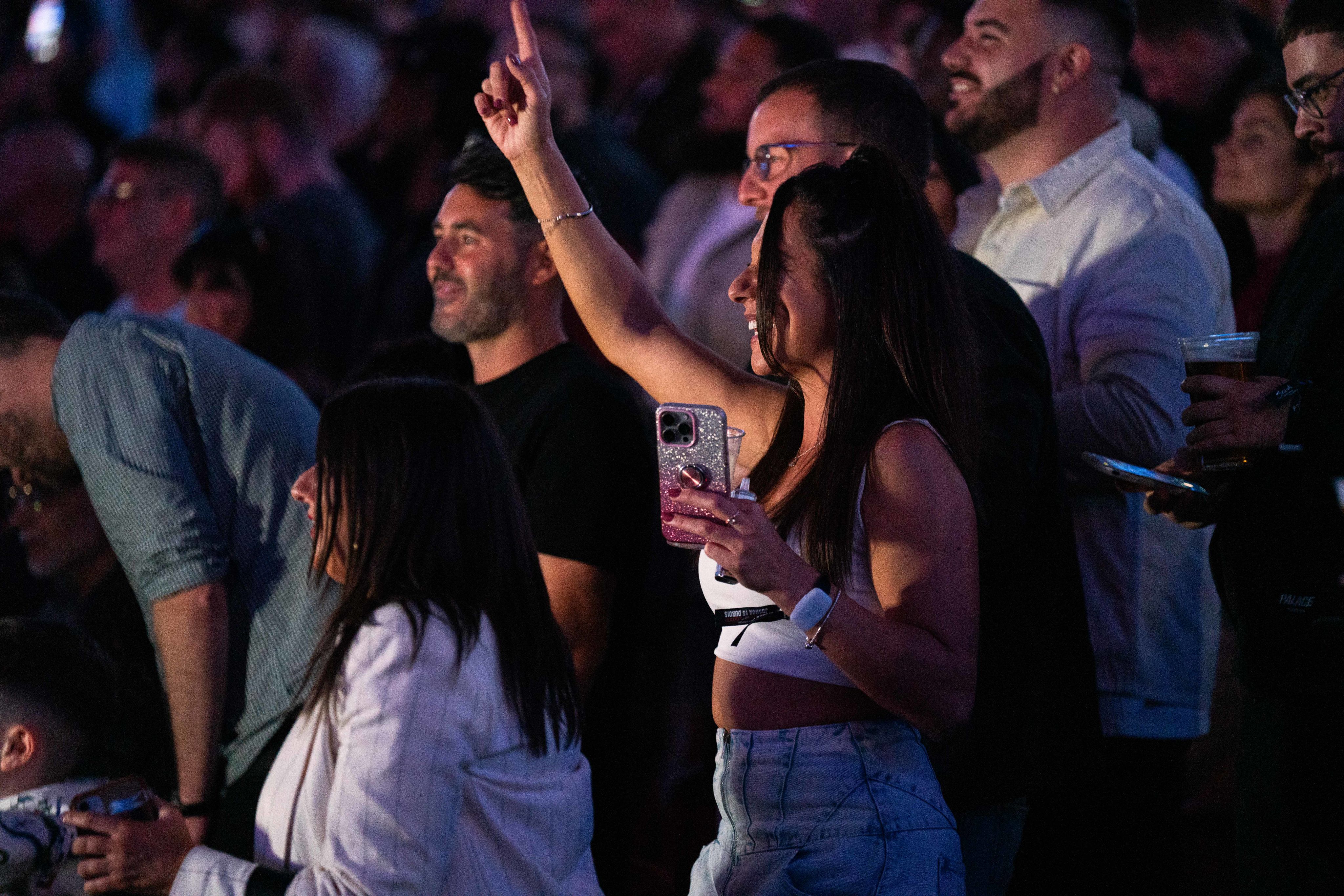 A boxing fan dances during Joshua Dubois