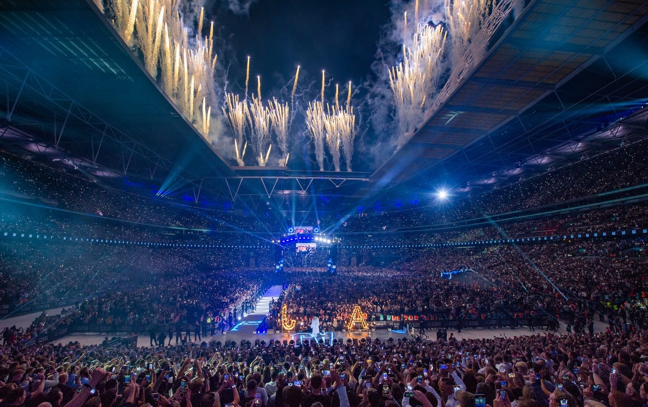 Fireworks are released from the roof and arch of the stadium