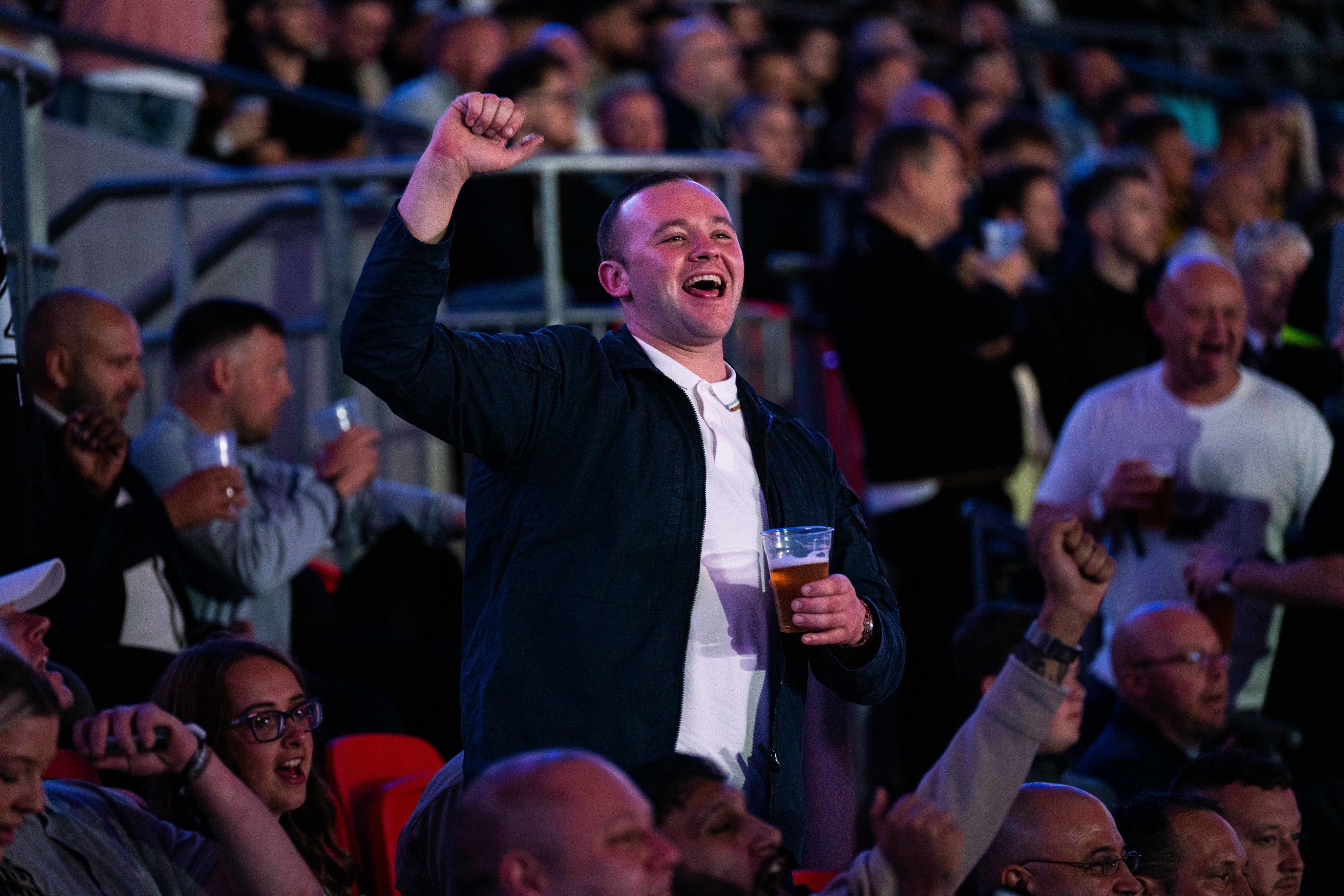 A boxing fan celebrates inside the stadium during Joshua Dubois