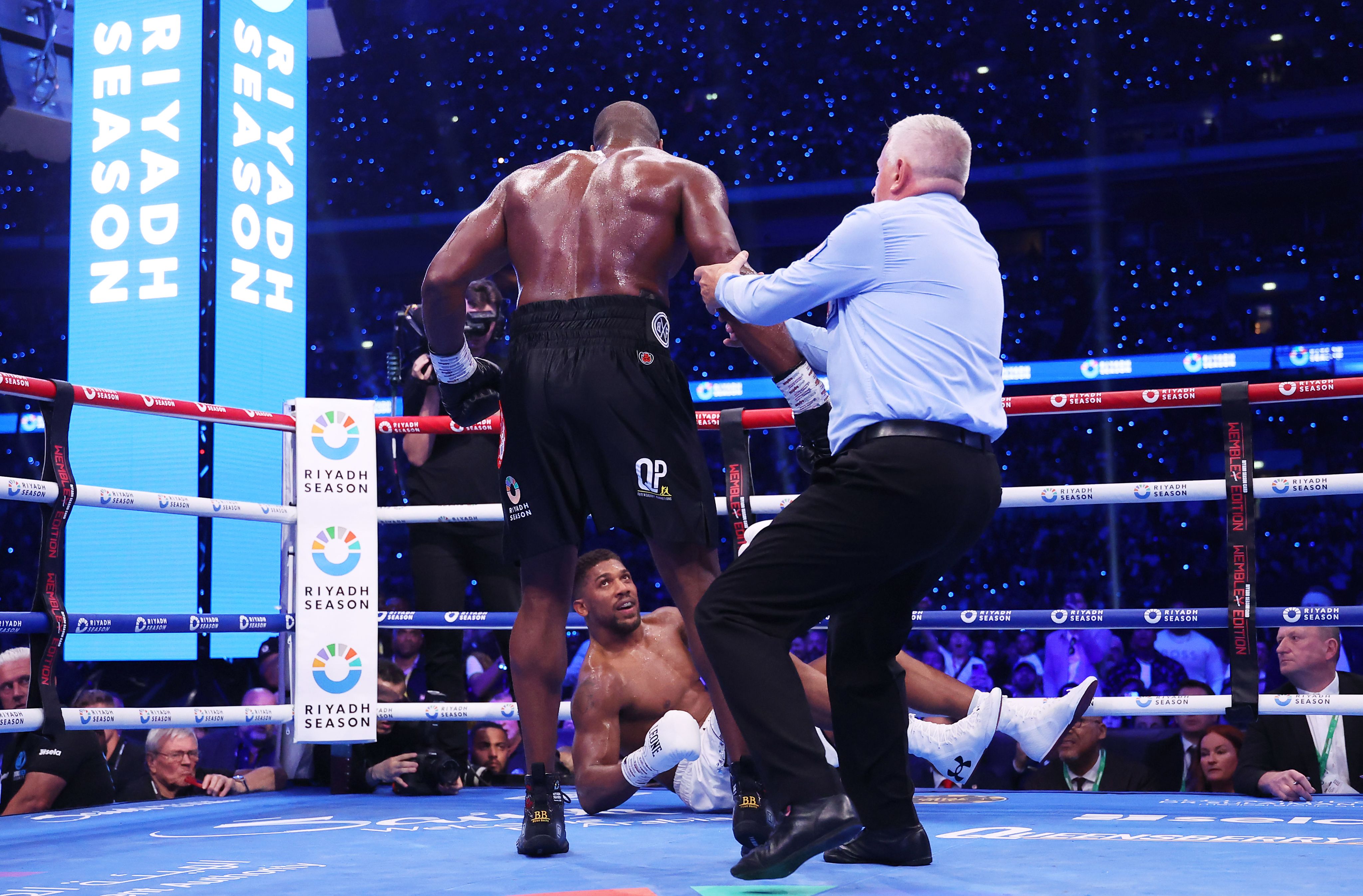 Anthony Joshua looks up at Dubois as he is knocked to the canvas