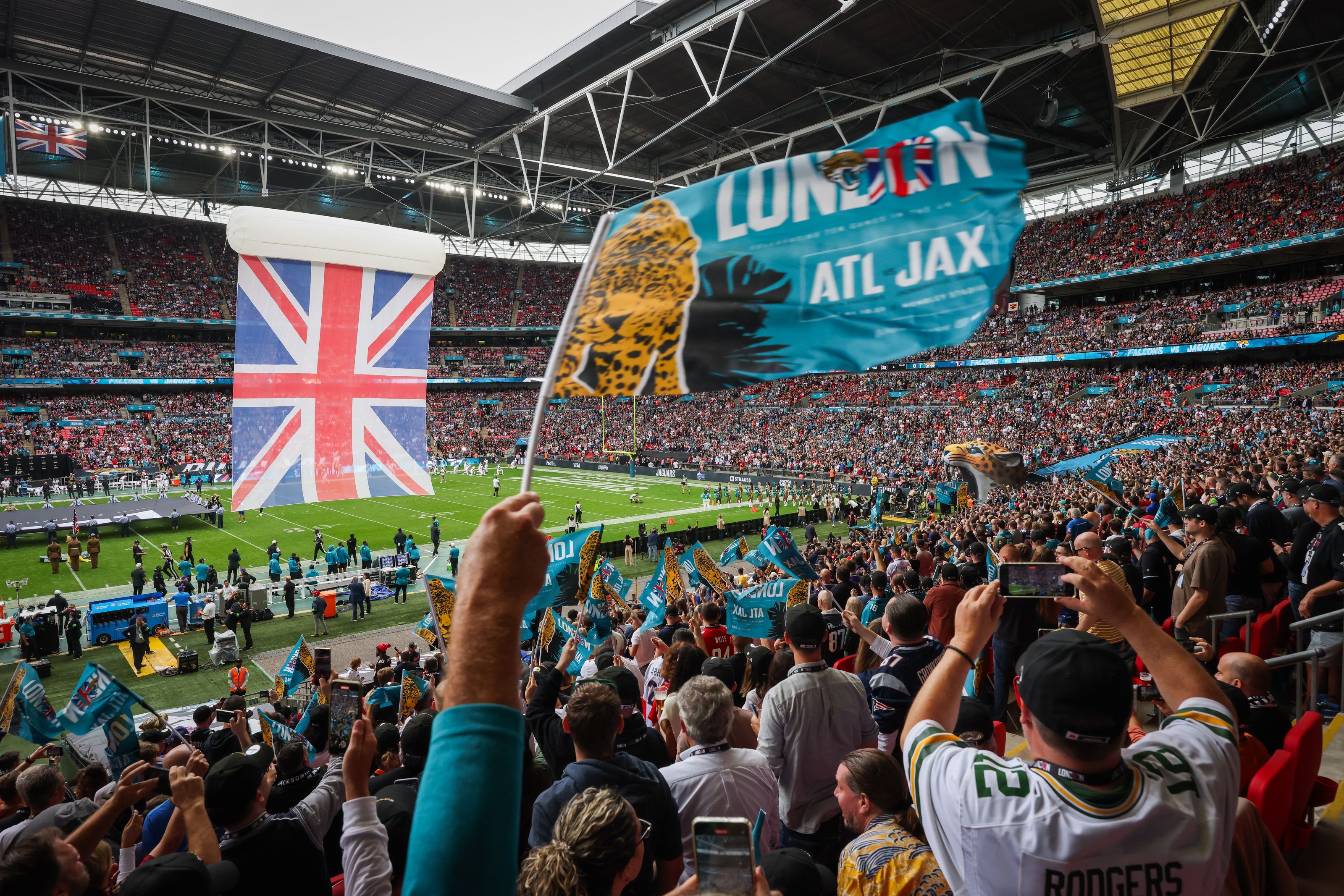 An NFL fan waves a flag during the 2023 NFL fixture at Wembley