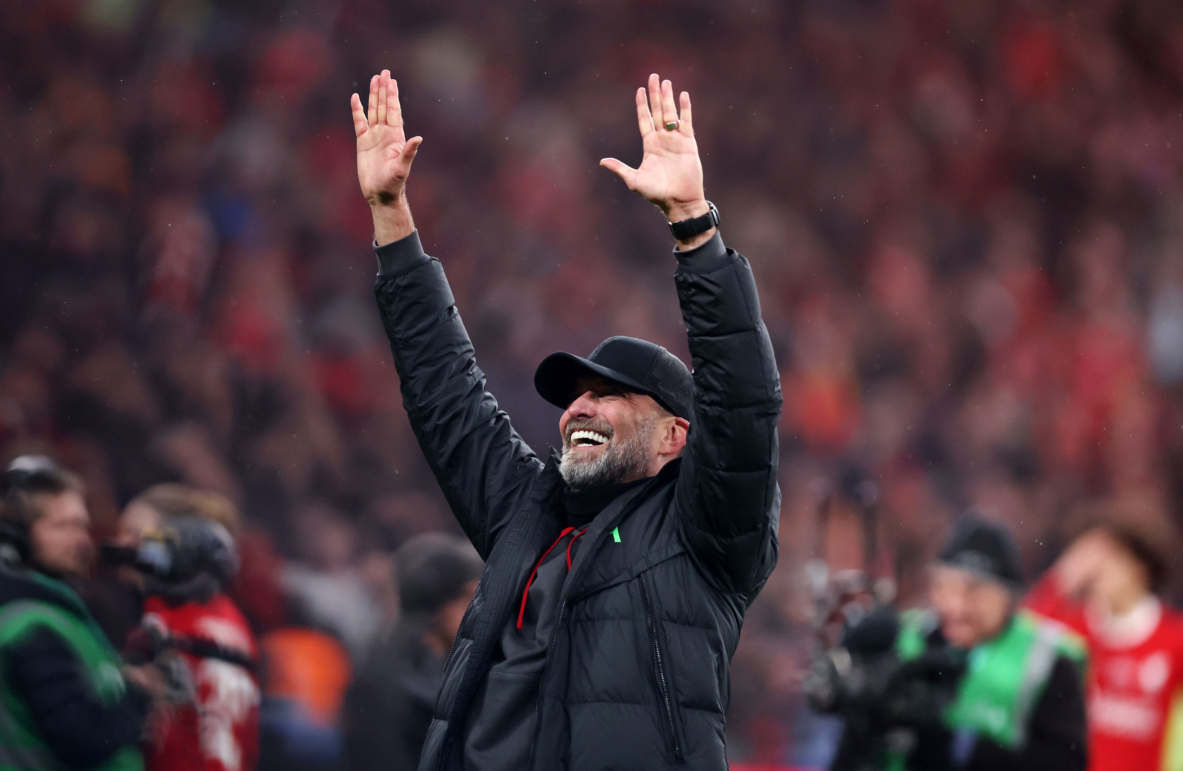 Jurgen Klopp lifts his arms aloft as he celebrates winning the Carabao Cup Trophy